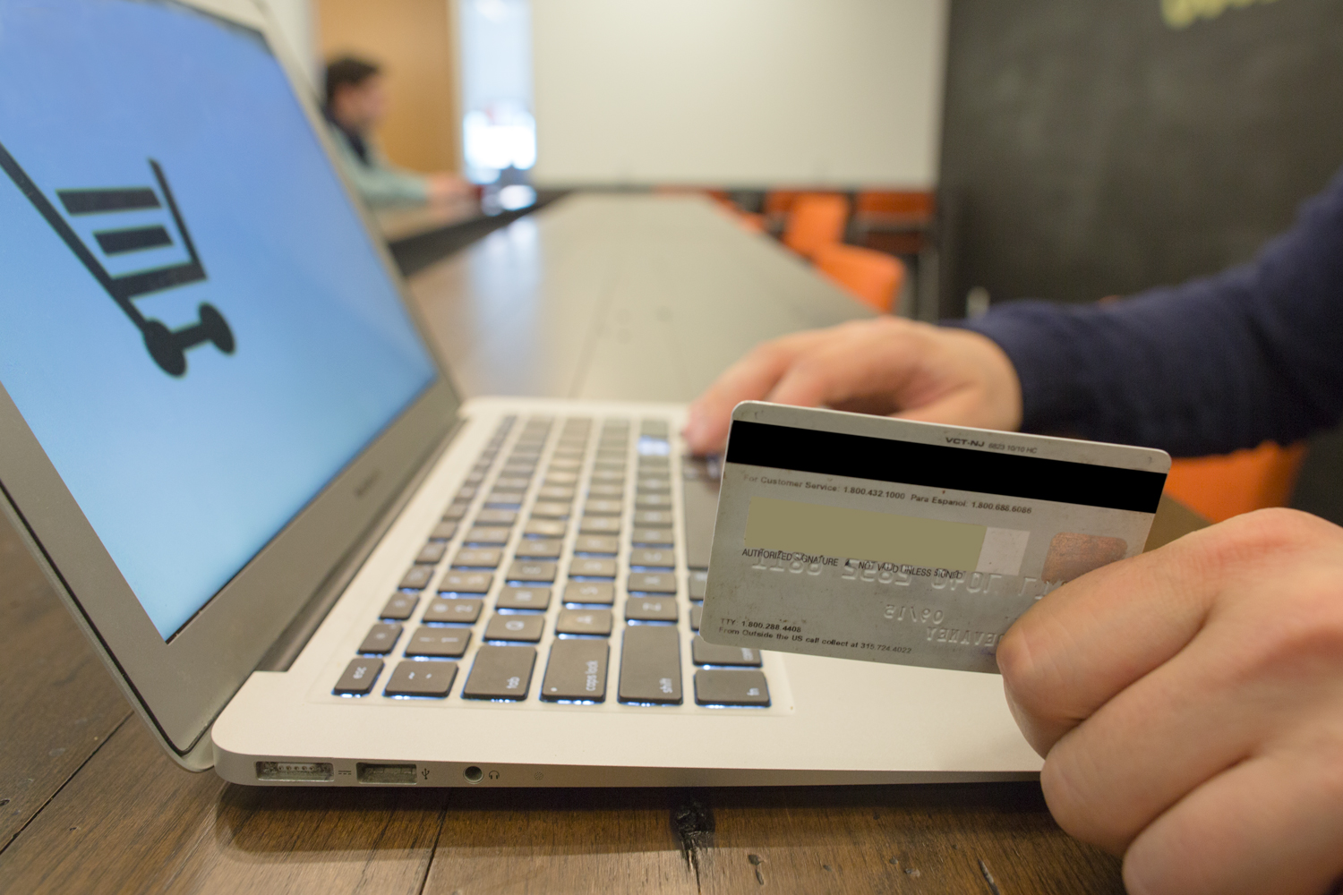 man with credit card on computer