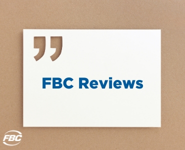 a white sign that says FBC Reviews on a corkboard background